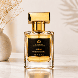 RocheHayatt Sarva unisex perfume in a luxury gold-capped bottle surrounded by burgundy satin, roses, jasmine flowers, and sandalwood pieces.