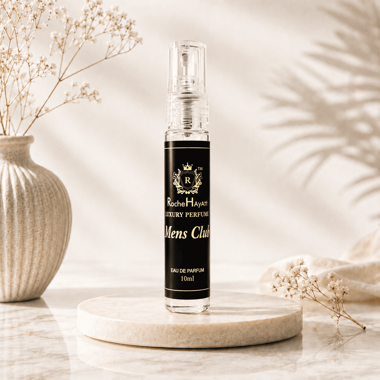 ocheHayatt Mens Club 10ml Eau de Parfum tester bottle displayed on a beige marble podium with soft natural lighting, dried flowers, and a premium minimalist background.