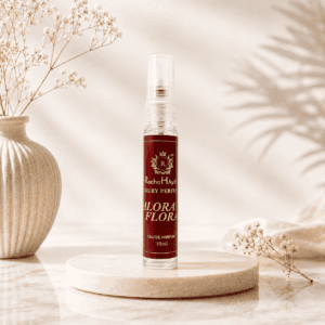 Valorant Flora inspired by Gucci Flora perfume in a 10ml travel-size spray bottle displayed on a beige marble podium with soft floral décor and elegant natural lighting.
