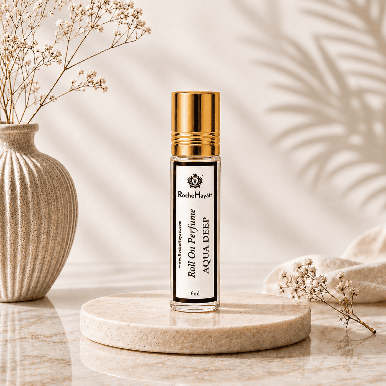 RocheHayatt Aqua Deep 6ml roll-on perfume bottle with golden cap on an elegant beige background.